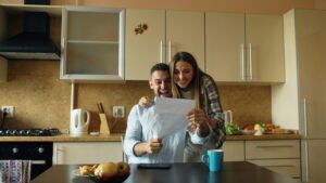 A family reviewing a life insurance policy document at home.